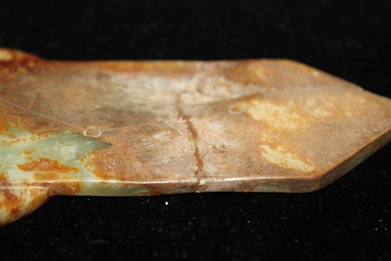 A Chinese yellow and russet jade tablet (gui), Ming dynasty or later, 19.1cm, broken and restored at pointed end, wood stand.